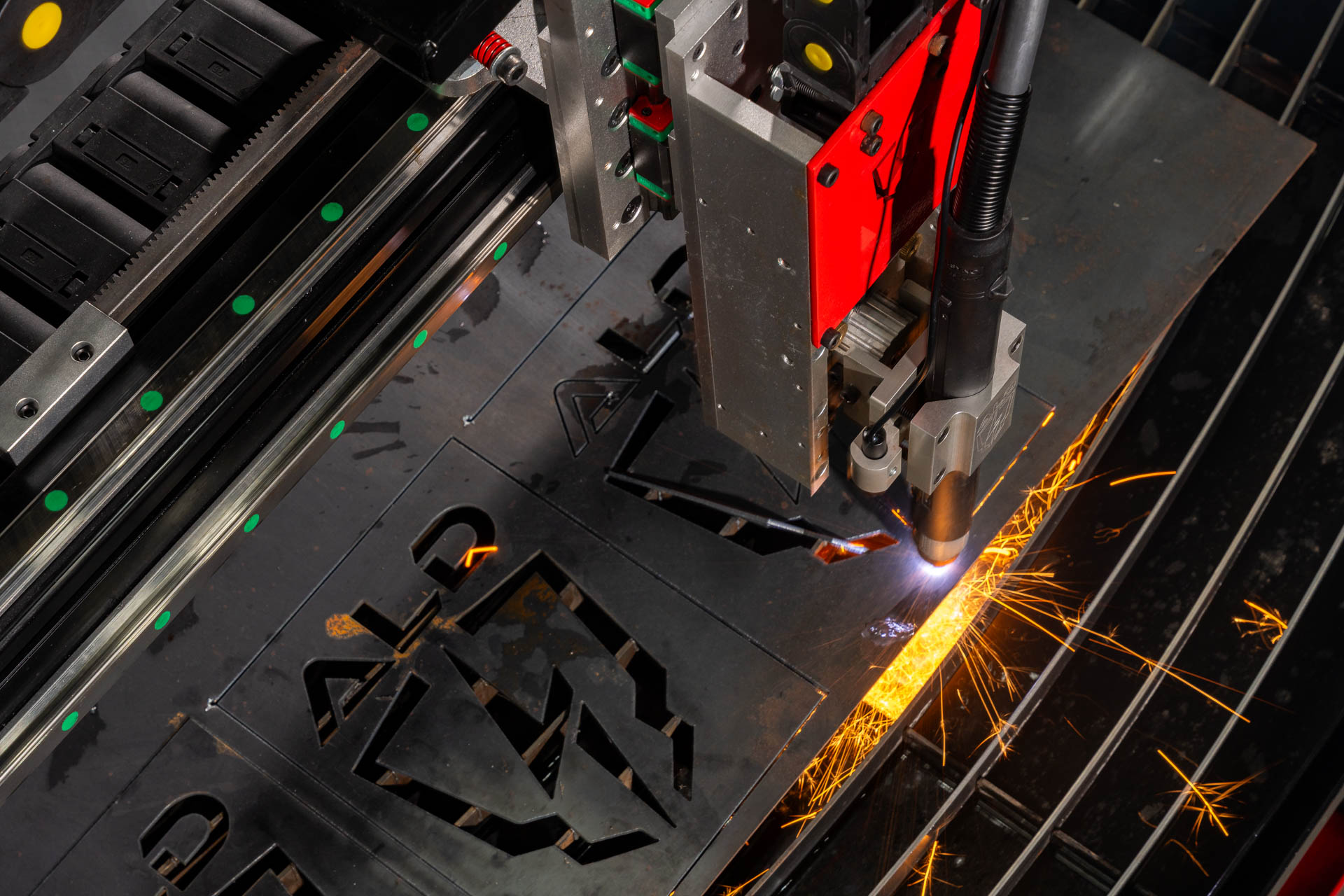 Arc Max in action — cut shapes visible on plate surrounded by sparks.